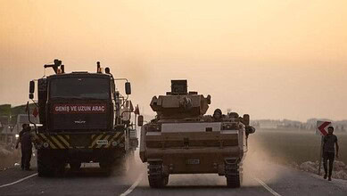 Turkish military vehicles on the road amid Syria conflict tensions.