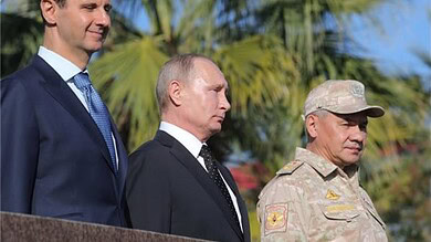 Vladimir Putin with Middle Eastern officials during a diplomatic meeting.
