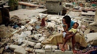 Amid Haiti protest violence, a woman and child navigate through debris and destruction.