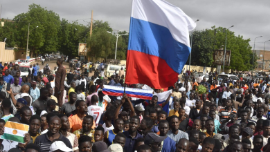 Demonstrators raise the Russian flag during an Independence Day demonstration in Niamey, Niger's capital, on August 3, 2023.