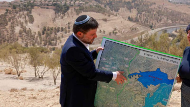 Israeli far-right Finance Minister Bezalel Smotrich holds a map of an area near the settlement of Maale Adumim