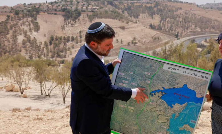 Israeli far-right Finance Minister Bezalel Smotrich holds a map of an area near the settlement of Maale Adumim