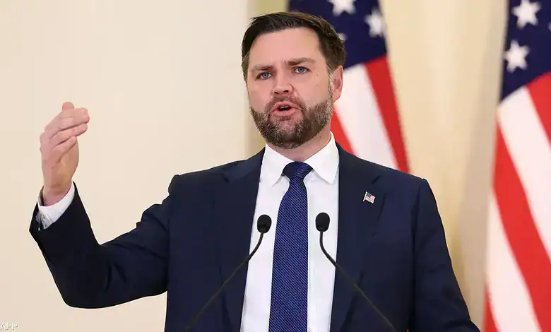 Politician delivering speech at a press event, emphasizing key policies with American flags behind h.
