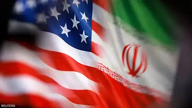 US and Iran flags close-up, symbolizing diplomatic relations.